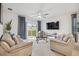 Comfortable living room with two sofas, coffee table, and sliding glass door to backyard at 723 Chinoy Rd, Davenport, FL 33837