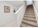 Elegant staircase with carpeted steps and white railings at 723 Chinoy Rd, Davenport, FL 33837
