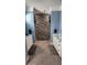 Double vanity bathroom with stone feature wall, and large shower at 780 Waterfern Trail Dr, Auburndale, FL 33823
