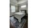 Bright bedroom with dark hardwood floors and window seating at 780 Waterfern Trail Dr, Auburndale, FL 33823