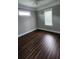 Spacious bedroom with dark hardwood floors and neutral walls at 780 Waterfern Trail Dr, Auburndale, FL 33823
