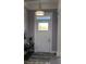 Bright entryway with tile flooring and elegant light fixture at 780 Waterfern Trail Dr, Auburndale, FL 33823