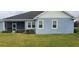 Rear view of house showcasing screened patio and lawn at 780 Waterfern Trail Dr, Auburndale, FL 33823