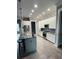 Modern kitchen with white cabinets and large island at 780 Waterfern Trail Dr, Auburndale, FL 33823