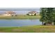 Stunning lakefront view with luxury homes and lush landscaping at 780 Waterfern Trail Dr, Auburndale, FL 33823