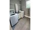 Convenient laundry room with washer, dryer, and extra shelving at 780 Waterfern Trail Dr, Auburndale, FL 33823