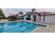Community lap pool with clubhouse in the background at 780 Waterfern Trail Dr, Auburndale, FL 33823