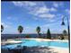 Relaxing community pool with lake views and ample seating at 780 Waterfern Trail Dr, Auburndale, FL 33823