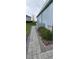 Sidewalk path beside home with landscaping and gray pavers at 780 Waterfern Trail Dr, Auburndale, FL 33823
