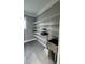 Laundry area with utility sink and ample storage shelving at 780 Waterfern Trail Dr, Auburndale, FL 33823