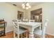 White farmhouse dining table with four chairs in bright dining room at 805 Willow Ln, Bartow, FL 33830