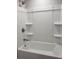 View of the bathroom shower and tub combination with a white surround at 809 Lincoln St, Babson Park, FL 33827