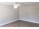 A bright bedroom featuring durable wood-look flooring and a modern ceiling fan at 809 Lincoln St, Babson Park, FL 33827
