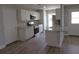 A modern kitchen features stainless steel appliances, granite countertops, and wood-look flooring at 809 Lincoln St, Babson Park, FL 33827