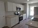 Modern kitchen featuring stainless steel appliances, granite countertops, and custom white cabinetry at 809 Lincoln St, Babson Park, FL 33827