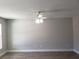 A spacious living area with modern light fixture, durable wood-look flooring, and neutral paint at 809 Lincoln St, Babson Park, FL 33827