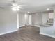 Open-concept living area with durable wood-look flooring and view of the modern kitchen island at 809 Lincoln St, Babson Park, FL 33827
