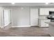 View of the open living room area featuring hardwood floors and white kitchen cabinets at 809 Lincoln St, Babson Park, FL 33827