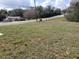 An empty grassy lot in a quiet neighborhood on a sunny day at 809 Lincoln St, Babson Park, FL 33827