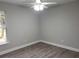 Spacious bedroom with wood-look flooring and a large window at 834 Wildabon Ave, Lake Wales, FL 33853