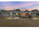 Back exterior view of the house, featuring a screened porch and lawn at 848 Casselberry Dr, Lake Wales, FL 33853