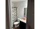 Clean bathroom with shower/tub combo, vanity, and dark brown cabinets at 932 Grandin St, Davenport, FL 33837