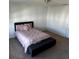 Bedroom with a queen bed and a bench at the foot of the bed at 932 Grandin St, Davenport, FL 33837