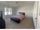 Bedroom with a queen bed, TV stand, and window at 932 Grandin St, Davenport, FL 33837