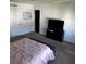 Bedroom with queen bed, TV stand and ample floor space at 932 Grandin St, Davenport, FL 33837