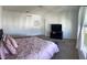 Spacious bedroom with a queen bed and large windows at 932 Grandin St, Davenport, FL 33837