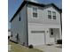 Modern two-story townhome with gray siding and a one-car garage at 932 Grandin St, Davenport, FL 33837