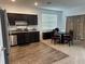 Modern kitchen with dark cabinets and a breakfast bar at 932 Grandin St, Davenport, FL 33837