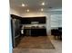 Modern kitchen with dark wood cabinets and granite countertops at 932 Grandin St, Davenport, FL 33837
