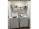Laundry room with washer, dryer, and shelving for storage at 932 Grandin St, Davenport, FL 33837
