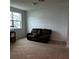 Spacious living room with a comfortable brown couch at 932 Grandin St, Davenport, FL 33837