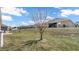 Large backyard with a grassy area and screened porch at 1153 Legatto Loop, Dundee, FL 33838