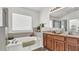 Main bathroom with a bathtub, double vanity, and tiled floors at 1153 Legatto Loop, Dundee, FL 33838
