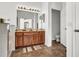 Double vanity bathroom with a large mirror and tiled floor at 1153 Legatto Loop, Dundee, FL 33838
