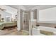 Bathroom with a shower, bathtub, and a view of the bedroom at 1153 Legatto Loop, Dundee, FL 33838