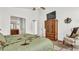 Spacious bedroom with a large bed, dresser, and an armchair at 1153 Legatto Loop, Dundee, FL 33838