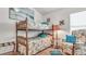Charming bedroom with a bunk bed, armchair, and beach-themed decor at 1153 Legatto Loop, Dundee, FL 33838