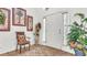 Bright entryway with a chair, plants, and a white door at 1153 Legatto Loop, Dundee, FL 33838