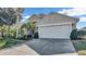 Two-story house with a white garage door and palm trees at 1153 Legatto Loop, Dundee, FL 33838