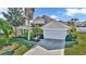 Two-story house with a white garage door and landscaping at 1153 Legatto Loop, Dundee, FL 33838