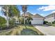 Two-story house with a white garage door and landscaped lawn at 1153 Legatto Loop, Dundee, FL 33838