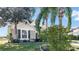 Two-story house with a brown garage door and palm trees at 1153 Legatto Loop, Dundee, FL 33838