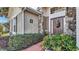 Brown front door with stone accents and a floral wreath at 1153 Legatto Loop, Dundee, FL 33838