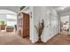 Hallway with a wooden cabinet and access to other rooms at 1153 Legatto Loop, Dundee, FL 33838
