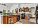 Kitchen with dark wood cabinets and black appliances at 1153 Legatto Loop, Dundee, FL 33838