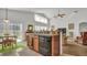 Bright kitchen with wood cabinets, black appliances, and an island at 1153 Legatto Loop, Dundee, FL 33838